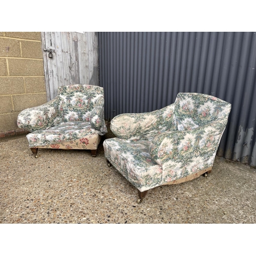 289 - A pair of deep seated country house armchairs chairs raised in square form tapering legs and brass c... 