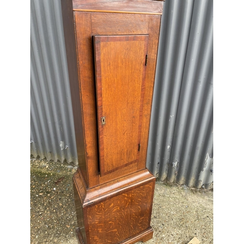 293 - An oak cased long case clock with brass dial