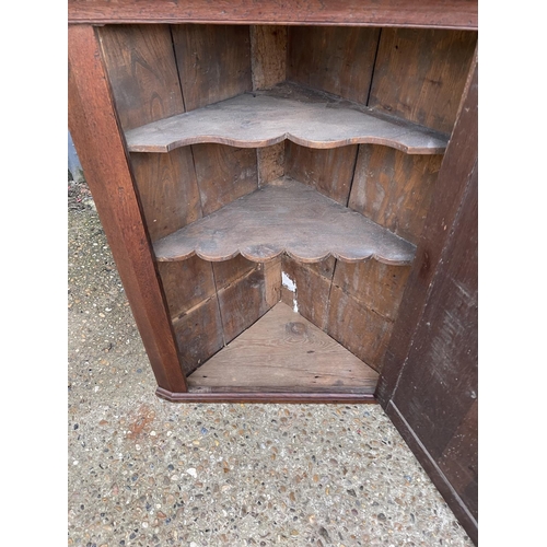 299 - An antique oak wall hanging corner cupboard