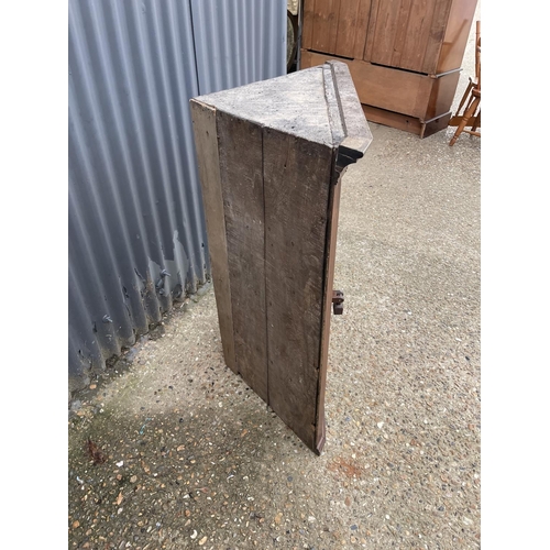 299 - An antique oak wall hanging corner cupboard