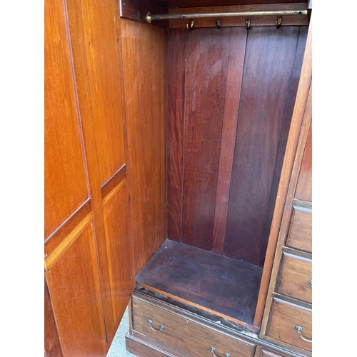 300 - An Edwardian mahogany three section compactum style wardrobe 140x47x205