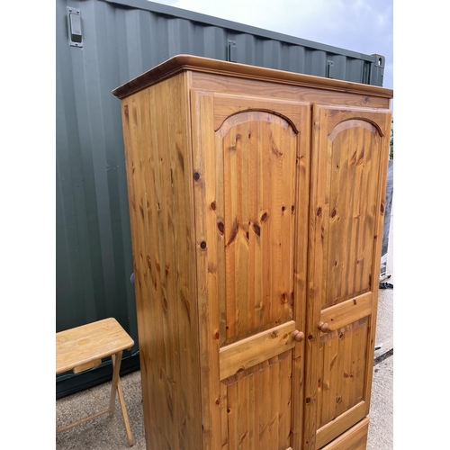 331 - A solid pine double wardrobe with drawer