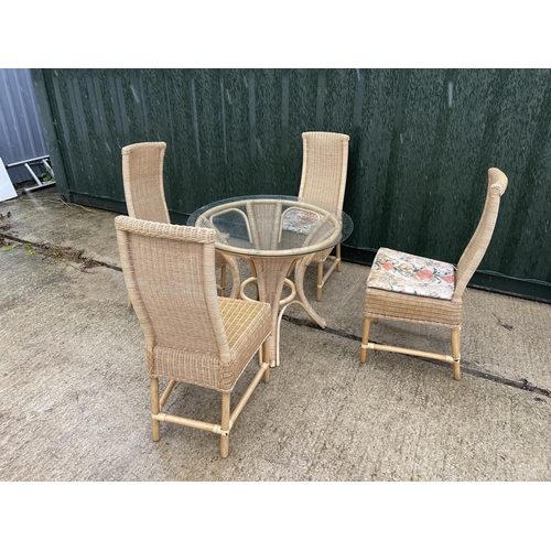 353 - A wicker conservatory glass top table and four chairs