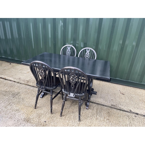 355 - A refectory style dining table together with four wheel back chairs