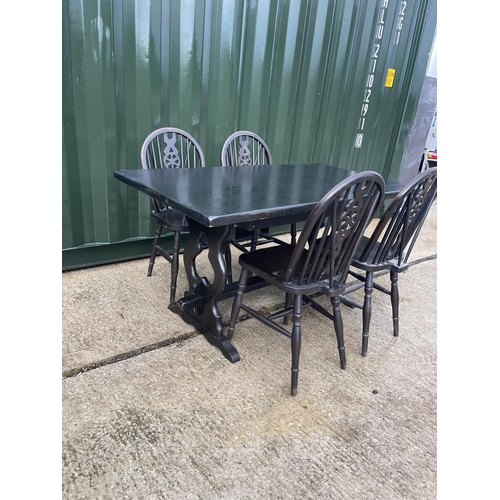 355 - A refectory style dining table together with four wheel back chairs