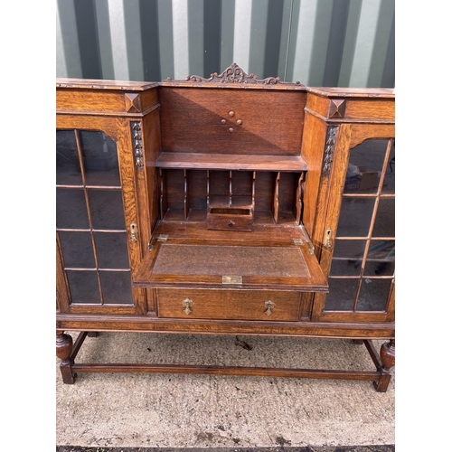 368 - An early 20th century oak bureau /  cabinet