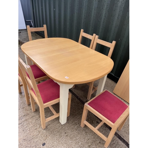 374 - An extending modern beach wood kitchen table together with six chairs and extension leaf