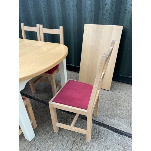 374 - An extending modern beach wood kitchen table together with six chairs and extension leaf