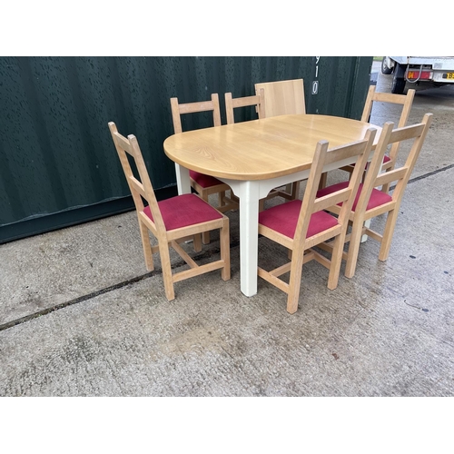 374 - An extending modern beach wood kitchen table together with six chairs and extension leaf