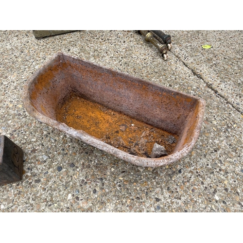 38 - A vintage heavy iron feed trough together with an iron weight