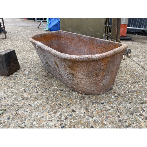 38 - A vintage heavy iron feed trough together with an iron weight