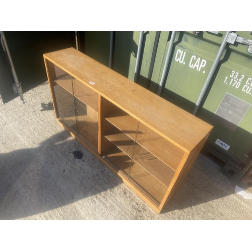 380 - A mid century light oak side by side glazed bookcase