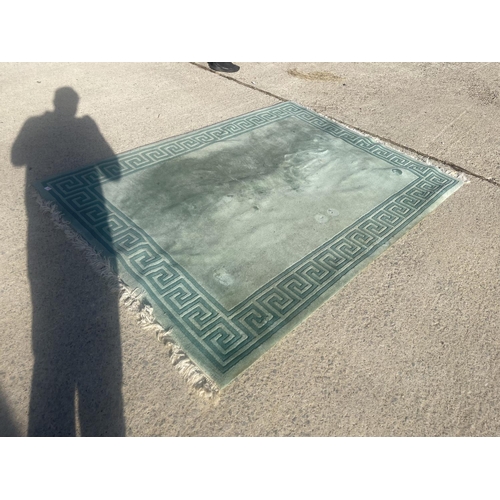 384 - A large green Chinese pattern rug