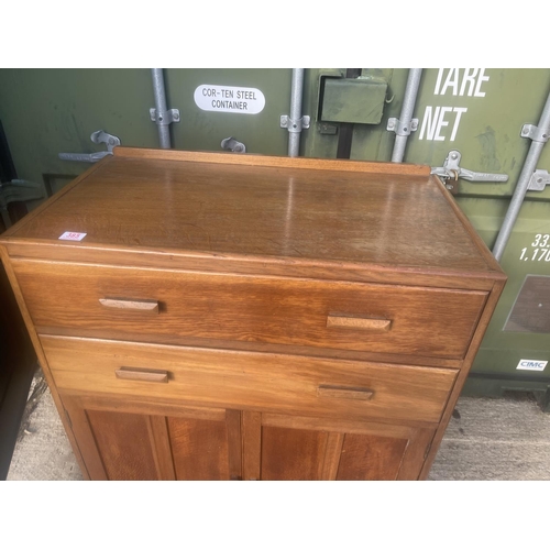 385 - A mid century oak two drawer tallboy