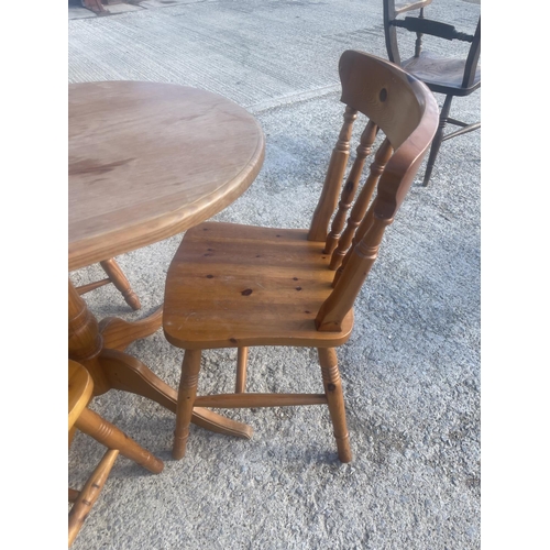 387 - A solid pine table and three chairs