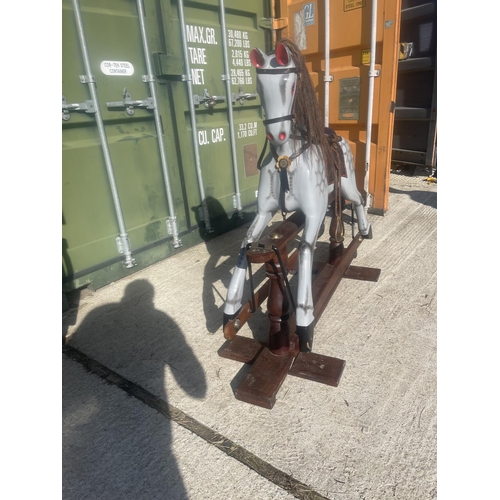 391 - A good quality grey rocking horse on swing base