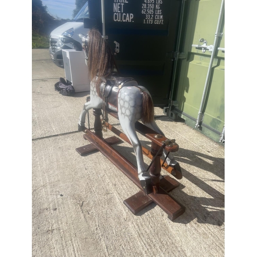 391 - A good quality grey rocking horse on swing base