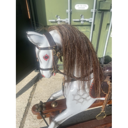 391 - A good quality grey rocking horse on swing base