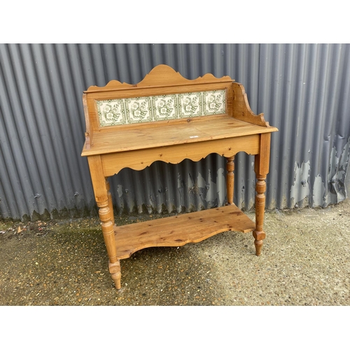 4 - A country pine washstand / side table with green pattern tile back