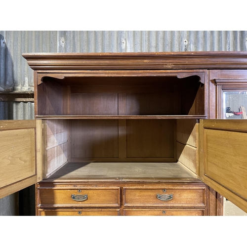 45 - A large three section compactum wardrobe labelled MAPLE & Co with linen press drawer section and mir... 