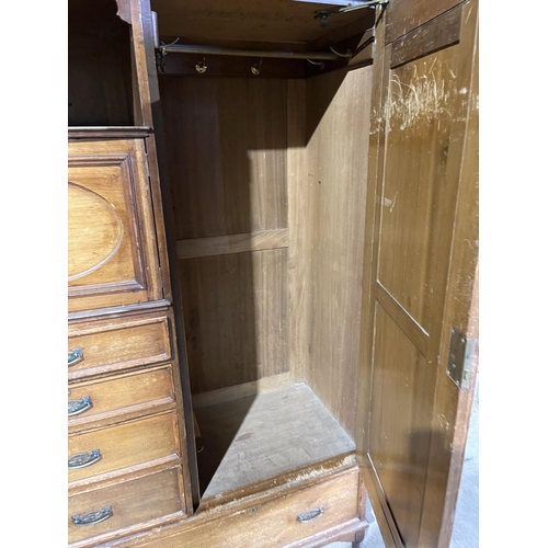 45 - A large three section compactum wardrobe labelled MAPLE & Co with linen press drawer section and mir... 