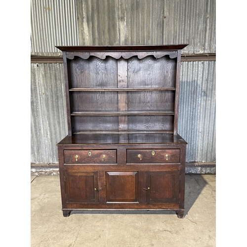 46 - An antique oak dresser with plate rack top over two drawer and three cupboard base 143x60x 195