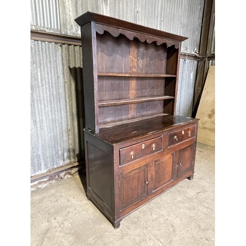 46 - An antique oak dresser with plate rack top over two drawer and three cupboard base 143x60x 195