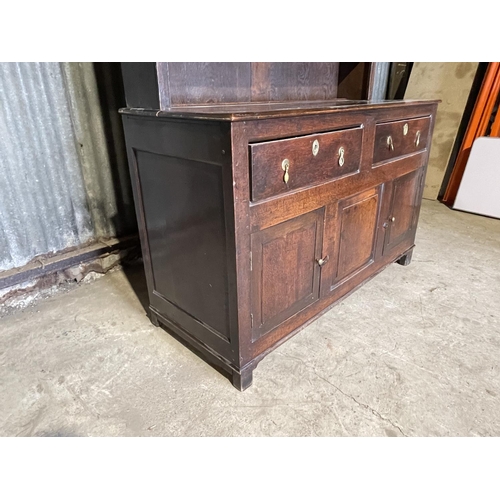 46 - An antique oak dresser with plate rack top over two drawer and three cupboard base 143x60x 195