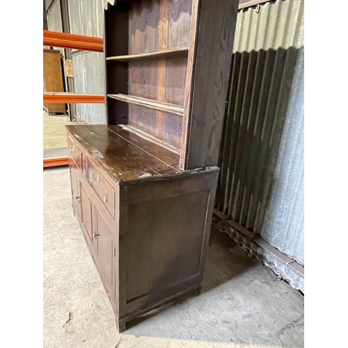 46 - An antique oak dresser with plate rack top over two drawer and three cupboard base 143x60x 195