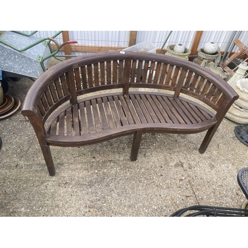 487 - A banana shaped hardwood garden bench