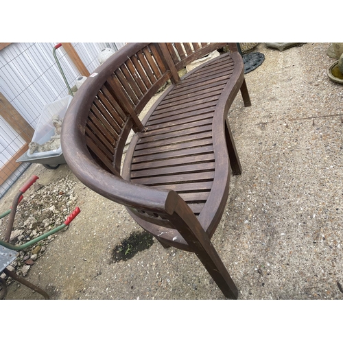 487 - A banana shaped hardwood garden bench