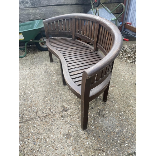 487 - A banana shaped hardwood garden bench