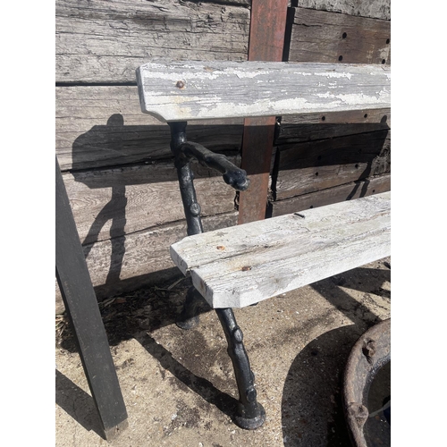 491 - A painted coalbrookdale iron framed garden bench with white painted slatted seat