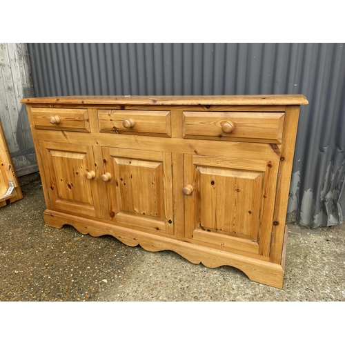 5 - A farmhouse style pine three drawer sideboard 156 x 42x88