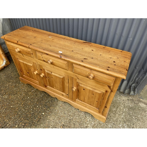 5 - A farmhouse style pine three drawer sideboard 156 x 42x88