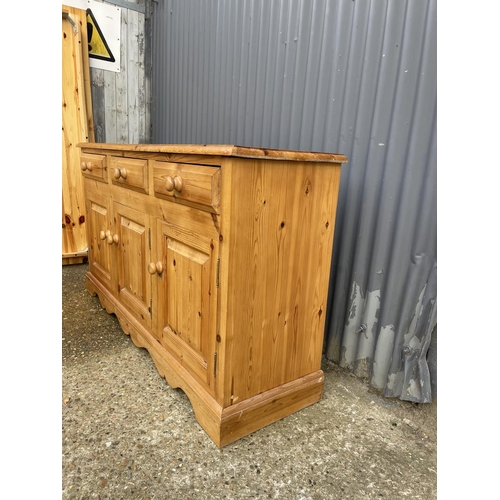 5 - A farmhouse style pine three drawer sideboard 156 x 42x88