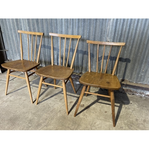 50 - A set of three ercol stick back kitchen chairs