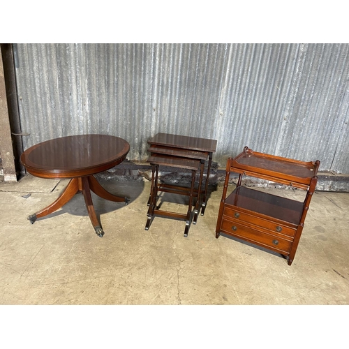 53 - A reproduction mahogany nest of three, oval coffee table and a Canterbury