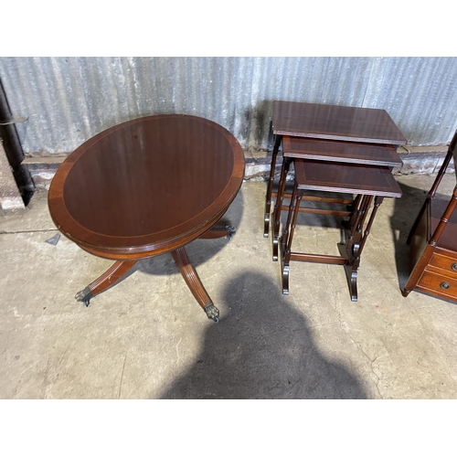 53 - A reproduction mahogany nest of three, oval coffee table and a Canterbury