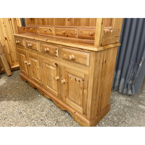 6 - A pine farmhouse style dresser with plate rack top over a long Four drawer base 178 x45 x195