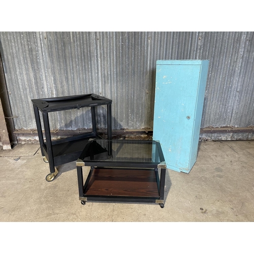 63 - A blue painted larder cupboard together with two black trolley tables