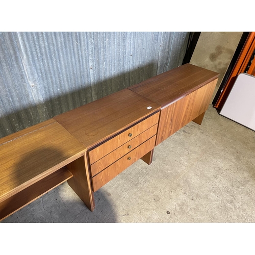 64 - A mid century teak bedroom set consisting of chest of three, desk with lift up top and ottoman