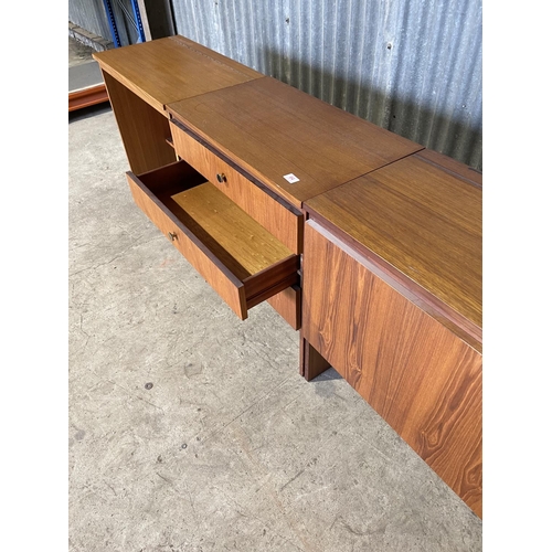 64 - A mid century teak bedroom set consisting of chest of three, desk with lift up top and ottoman