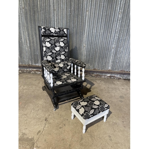 69 - A black painted and reccently reupholstered American style spring rocker chair together with a stool