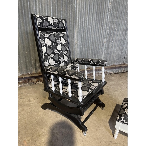 69 - A black painted and reccently reupholstered American style spring rocker chair together with a stool