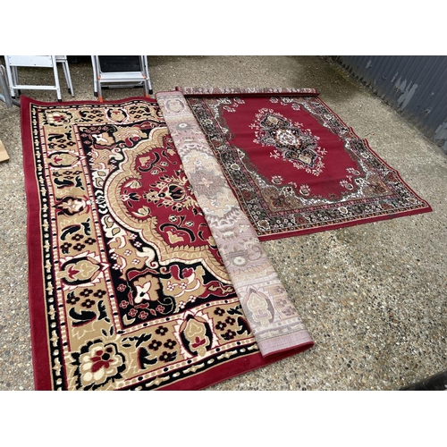 77 - Two large red pattern rugs