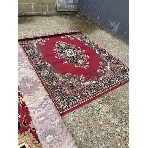 77 - Two large red pattern rugs