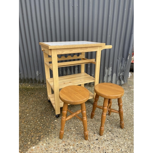 8 - A beech kitchen trolley together with two pine stools