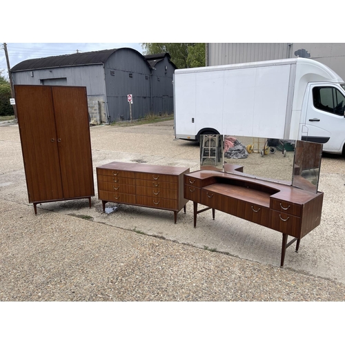 81 - A mid century teak three piece teak bedroom suite by meredew consisting of a chest, a dressing chest... 