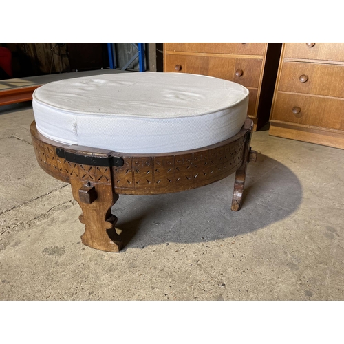 92 - A carved eastern style stool with white upholstered cushion top